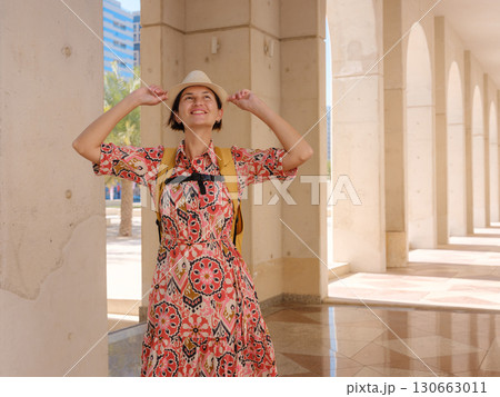 Young female tourist exploring iconic landmarks of the United Arab Emirates. Young female tourist exploring iconic landmarks of the United Arab Emirates. 130663011