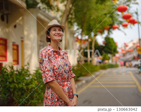 woman exploring streets of George Town, during Chinese New Year. 130663042