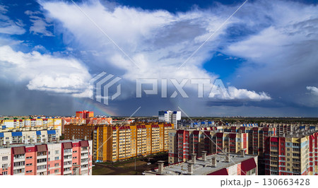 Amazing cloudy landscape above multi-colored residential buildings 130663428
