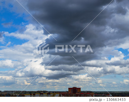 Cloudy sky over city apartment buildings Cloudy sky over city apartment buildings 130663433