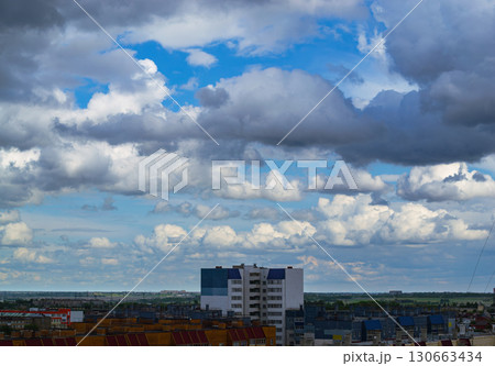 Cloudy sky over city apartment buildings 130663434