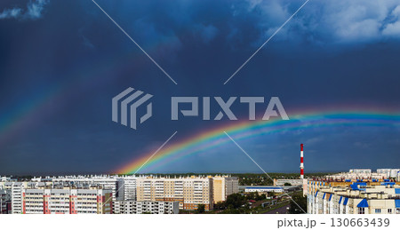 Double rainbow over city buildings after rain Double rainbow over city buildings after rain 130663439