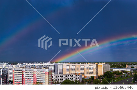 Fantastic beautiful rainbow over city buildings after rain 130663440