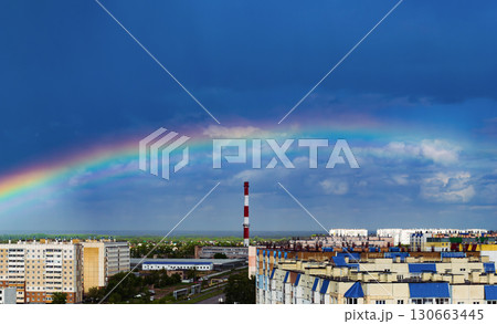 Fantastic beautiful rainbow over city buildings after rain 130663445
