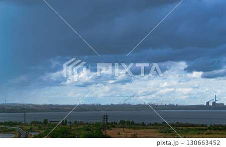 Gloomy rainy clouds hung over the city and the lake Gloomy rainy clouds hung over the city and the lake 130663452