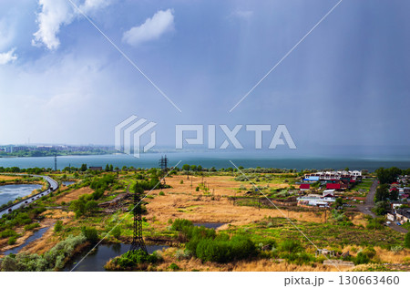 Heavy rainfall over countryside near lake Heavy rainfall over countryside near lake 130663460