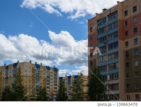 Multi-storey buildings on the background of clouds and sky 130663478