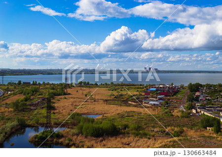 Power plant by lake under bright beautiful clouds Power plant by lake under bright beautiful clouds 130663484