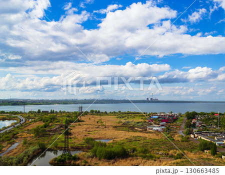 Power plant by lake under bright beautiful clouds 130663485
