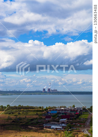 Power plant by lake under bright beautiful clouds Power plant by lake under bright beautiful clouds 130663488
