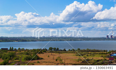 Power plant by lake under bright beautiful clouds Power plant by lake under bright beautiful clouds 130663491