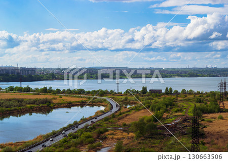 Scenic lake view with road and city skyline 130663506