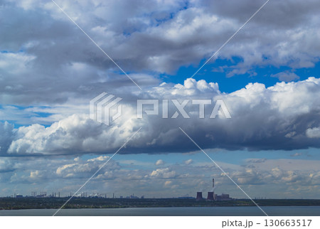 Storm clouds over lake and industrial skyline with power plant 130663517
