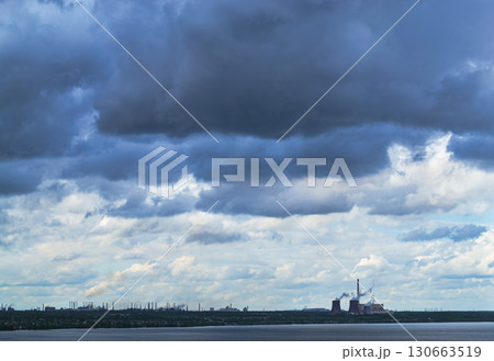 Storm clouds over lake and industrial skyline with power plant 130663519