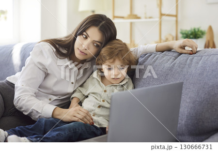 Mother and son watching cartoon for child development via laptop computer 130666731