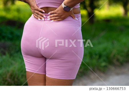 Closeup of plus size woman buttocks in pink sportswear 130666753