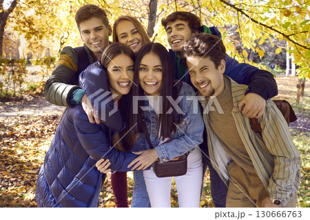 Group of happy friends hugging on nature in autumn 130666763