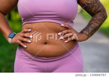 Athlete closeup of body in sportswear in park 130666767