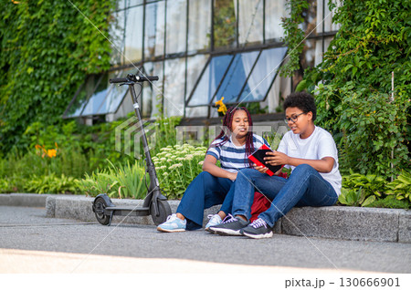 Two teens discussing something after school and looking involved 130666901