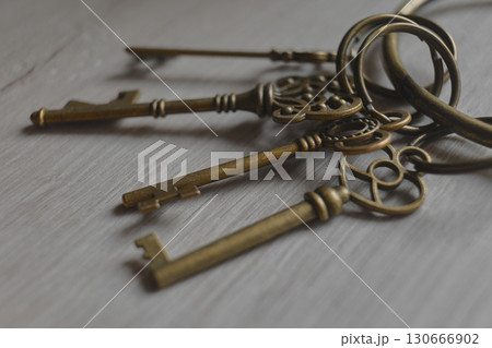 ornate keys displayed on rustic wood 130666902