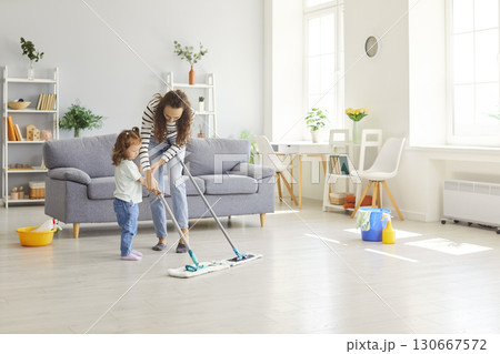 Happy playful funny active family, little helper, domestic chores game mother parent, babysitter  130667572