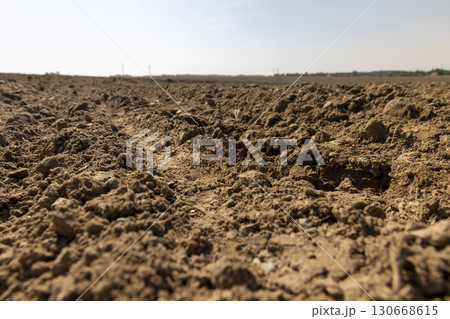 a field after harvest, a large field where agricultural activity is carried out in Europe 130668615