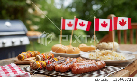 Grilling Canada Day feast in a backyard setting with sausages, vegetables, and festive decorations 130669722