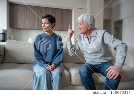 Irate shouting husband with hysterical behavior in toxic argument, undermining woman reality 130670315
