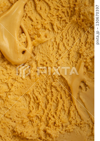 Creamy caramel ice cream close-up texture, rich and sweet frozen dessert background 130670397