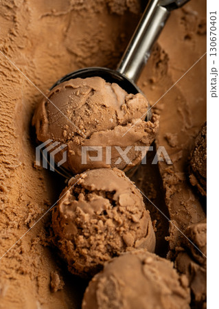Close-up of chocolate ice cream scoops with rich texture and creamy surface Close-up of chocolate ice cream scoops with rich texture and creamy surface 130670401