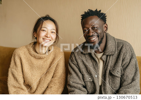 Happy couple enjoying quality time together in a cozy living room setting 130670513