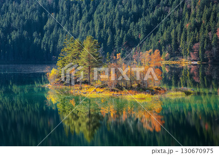 Fabulous autumn  landscape of islands with pine-trees in the middle of Eibsee lake. 130670975