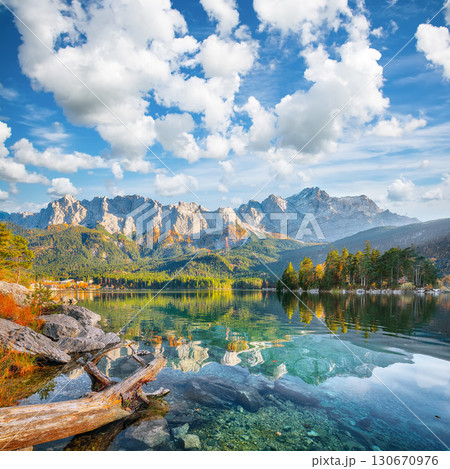 Stunning autumn landscape of Eibsee Lake in front of Zugspitze summit under sunlight. 130670976