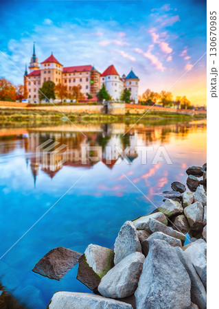 Amazing blurred morning view of Hartenfels castle on banks of the Elbe. Amazing blurred morning view of Hartenfels castle on banks of the Elbe. 130670985