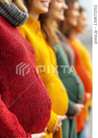 Close up of pregnant girls smiling together showcasing motherhood joy in vibrant colors 130671052