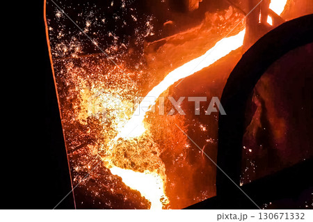 Molten iron stream in a steel mill. 130671332