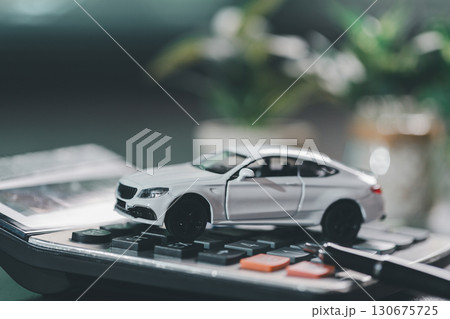 Client legal contract and finance document for business deal involving vehicle, agreements cover car loan, insurance, investment terms, with car key handed over to complete transaction. Client legal contract and finance document for business deal involving vehicle, agreements cover car loan, insurance, investment terms, with car key handed over to complete transaction. 130675725