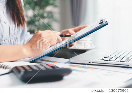 Business woman analyze calculate company financial, tax results office accounting statistics analytical research. calculating business balance prepare tax reduction. Tax deduction planning concept. Business woman analyze calculate company financial, tax results office accounting statistics analytical research. calculating business balance prepare tax reduction. Tax deduction planning concept. 130675902