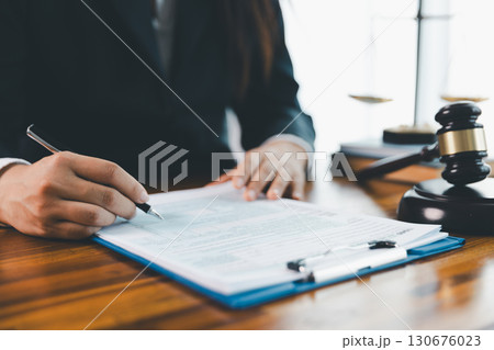 Justice and lawfirm concept. Female lawyer in office with brass scale. Woman hand gavel to bang. Law and justice trial session. Business lawyer notary stamping agreement, company secretary, validity. Justice and lawfirm concept. Female lawyer in office with brass scale. Woman hand gavel to bang. Law and justice trial session. Business lawyer notary stamping agreement, company secretary, validity. 130676023