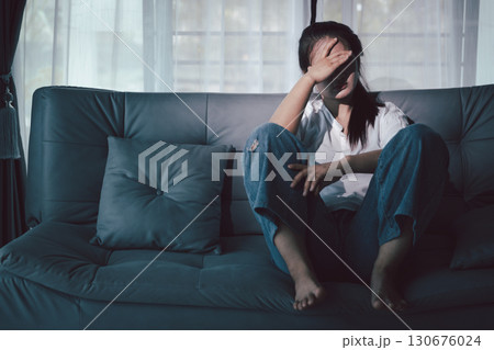 Despair sorrow person in empty dark room, Depressed young woman covering face with hands. Young woman coping with distress covering face. mental health concept. Boring sad upset frustrated stressed. Despair sorrow person in empty dark room, Depressed young woman covering face with hands. Young woman coping with distress covering face. mental health concept. Boring sad upset frustrated stressed. 130676024