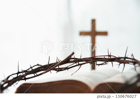 Crown of thorns and cross powerful symbols in Christianity, representing holy sacrifice of Jesus Christ in Bible and serving as enduring reminders of faith and core of Christian religion. Crown of thorns and cross powerful symbols in Christianity, representing holy sacrifice of Jesus Christ in Bible and serving as enduring reminders of faith and core of Christian religion. 130676027