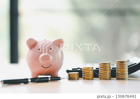Money box filled with coins, saving cash, banking wisely, making sound investments can build financial wealth, personal finance and overall economy through proper business and currency management. Money box filled with coins, saving cash, banking wisely, making sound investments can build financial wealth, personal finance and overall economy through proper business and currency management. 130676491