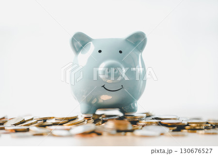 Money box filled with coins, saving cash, banking wisely, making sound investments can build financial wealth, personal finance and overall economy through proper business and currency management. Money box filled with coins, saving cash, banking wisely, making sound investments can build financial wealth, personal finance and overall economy through proper business and currency management. 130676527