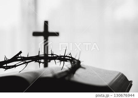 Crown of thorns and cross powerful symbols in Christianity, representing holy sacrifice of Jesus Christ in Bible and serving as enduring reminders of faith and core of Christian religion. Crown of thorns and cross powerful symbols in Christianity, representing holy sacrifice of Jesus Christ in Bible and serving as enduring reminders of faith and core of Christian religion. 130676944