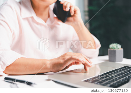 Closeup of woman holding smartphone hand shows using mobile phone technology browse online shopping, social media, engaging in fast-paced world of cyberspace. online shopping, social media network 130677180