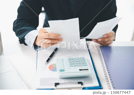 Woman calculating monthly home expenses, taxes, bank account balance and credit card bills payment, Income is not enough for expenses. financial planning, business calculate tax, investment finance. Woman calculating monthly home expenses, taxes, bank account balance and credit card bills payment, Income is not enough for expenses. financial planning, business calculate tax, investment finance. 130677447