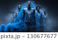 Basketball players emerging from blue smoke: teamwork and determination 130677677