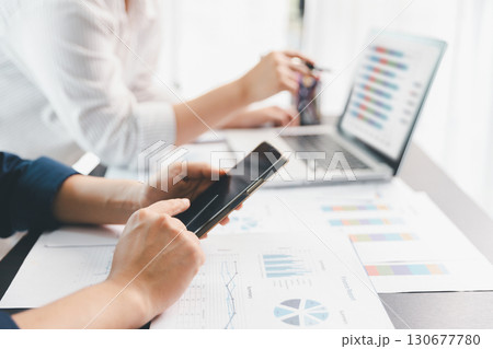 Business meeting, data analytics or women with graph presentation in office. Chart, analysis accounting team brainstorming economy, inflation or solution. business project finance investment concept. 130677780