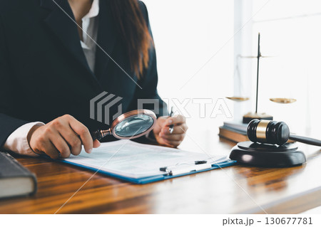 Justice and lawfirm concept. Female lawyer in office with brass scale. Woman hand gavel to bang. Law and justice trial session. Business lawyer notary stamping agreement, company secretary, validity. 130677781