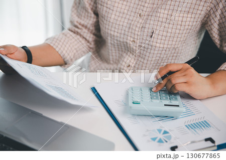 Businesswoman analysis with financial data, marketing business strategy project, Business financing accounting banking concept, finances, calculate about cost to real estate investment, tax system. Businesswoman analysis with financial data, marketing business strategy project, Business financing accounting banking concept, finances, calculate about cost to real estate investment, tax system. 130677865